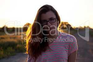 Beautiful teenager girl in the light of sunset