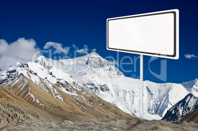 Blank billboard surround by mountain range.