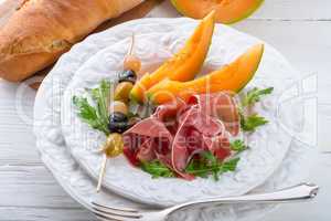 Ham with melon and olives