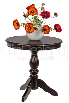 Bouquet of artificial poppies in a vase on the round table, isol