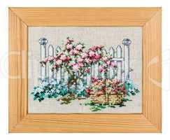 Embroidered picture in the frame, isolated on white background