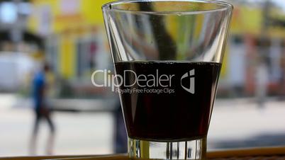 glass of soda with city background