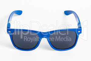 Blue plastic sunglasses isolated on white