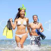 Beach couple having fun on vacation travel snorkel