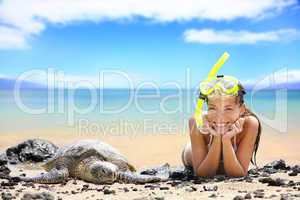 Beach travel woman on Hawaii with sea sea turtle