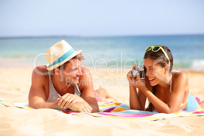 Beach fun couple travel - woman taking photo