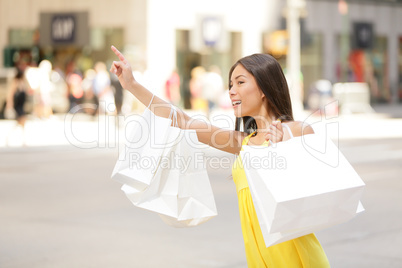 Shopping woman in New York City looking for taxi