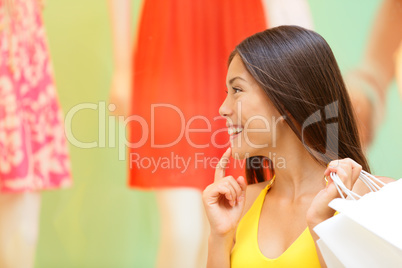 Shopping woman looking at window display at store