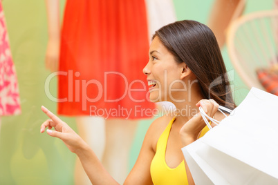 Shopping woman looking at clothing window display