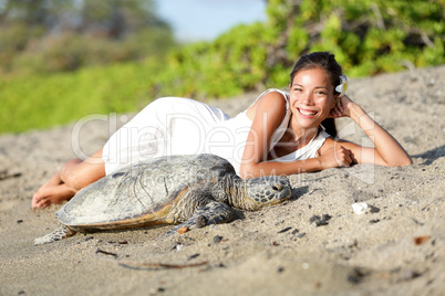 Turtle and woman lying on beach, Big Island Hawaii