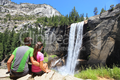 Hikers couple resting in Yosemite park - waterfall
