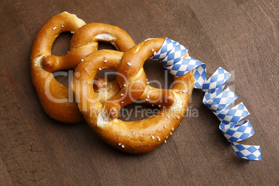 Two typical bavarian pretzel with white and blue streamer