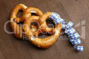 Two typical bavarian pretzel with white and blue streamer