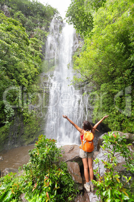 Happy hiker - Hawaii tourists hiking by waterfall