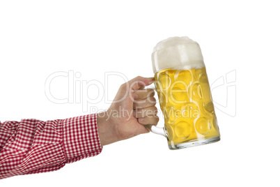 Man in traditional Bavarian shirt holds mug of beer