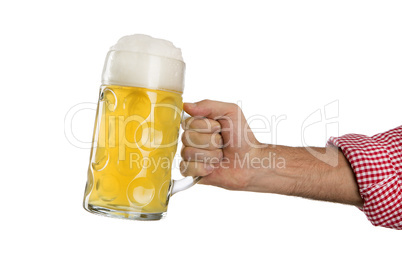 Man in traditional Bavarian shirt holds mug of beer