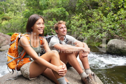 Hikers couple relaxing by river
