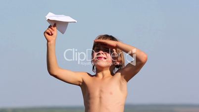 Boy launches a paper airplane.Child playing with paper airplane.