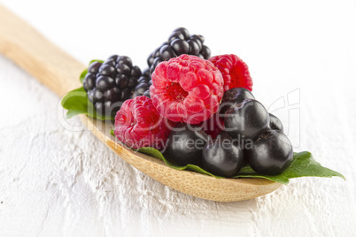 forest berries in wooden spoon