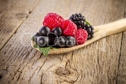 forest berries in wooden spoon