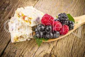 muesli bars with fresh berries in spoon