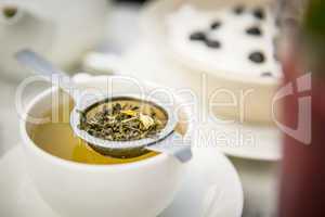Tee mit Teetasse und Teesieb