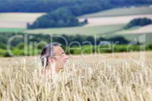 Man hiding in corn field