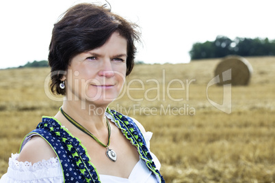 Portrait of woman in Dirndl on the field