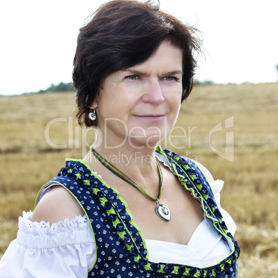 Portrait of woman in Dirndl on the field