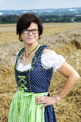 Portrait of woman in Dirndl on the field