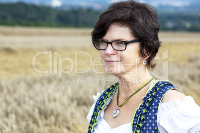 Portrait of woman in Dirndl on the field