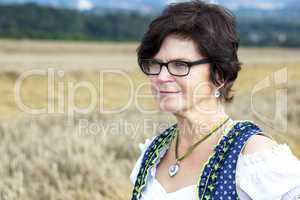 Portrait of woman in Dirndl on the field