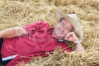 man who is down on straw and takes a rest