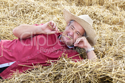 man who is down on straw and takes a rest