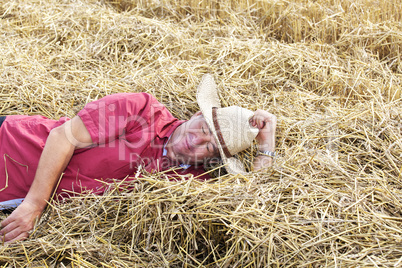 man who is down on straw and takes a rest