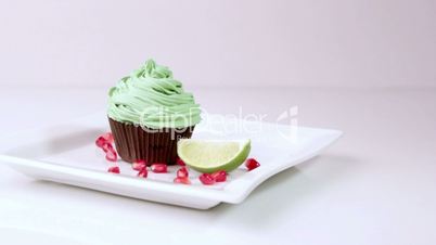 Festive cupcakes with almonds and fruit on a white background.