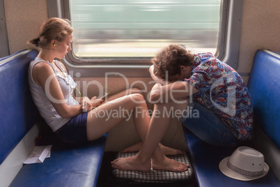 Teenagers boy and girl  in the train