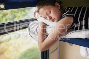 Teenage girl sleeps in train