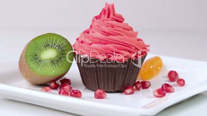 Festive cupcakes with almonds and fruit on a white background.
