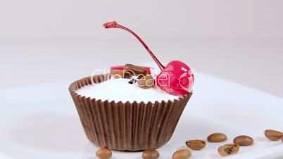 Festive cupcakes with almonds and fruit on a white background.