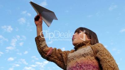 Boy with paper airplane. Close up.Boy on a blue sky background with plane was playing.