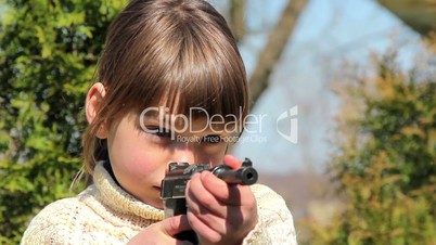 Boy with gun,boy playing weapon,little warrior.Juvenile delinquency.