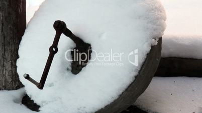 A circular wooden object with snow
