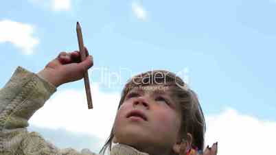 Boy with colored pencils,Child with pencils on sky background, paint in air