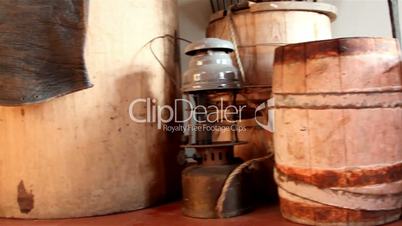 Three wooden barrels and an old lamp