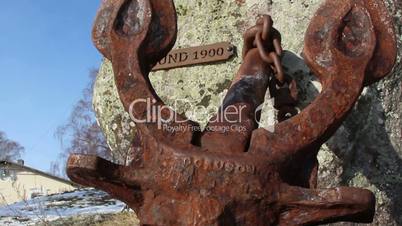 A rusty anchor from a rock