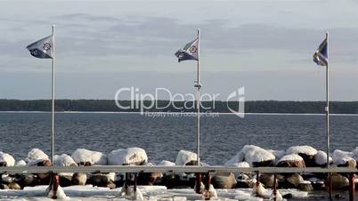 Three flags waving on the flag pole