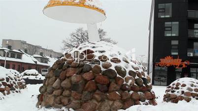 Some rocks formed into oblong shaped covered with snow