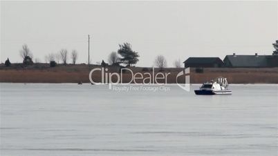 Blue boat on snow with red light