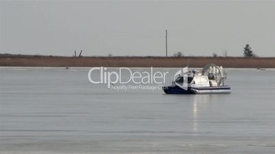 A blue boat on snow moving fast